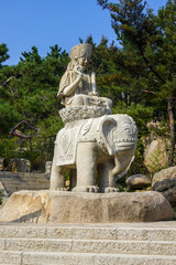 Fototapeta premium Carved elephant statue on raised stone plinth