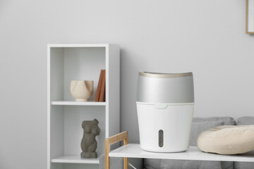Air humidifier on shelf in living room