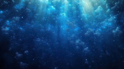 Fototapeta premium Underwater scene with sun rays penetrating deep blue ocean water filled with small air bubbles creating a serene and mysterious atmosphere