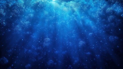 Underwater scene with deep blue water illuminated by sunlight rays and rising air bubbles creating a tranquil and mysterious underwater atmosphere
