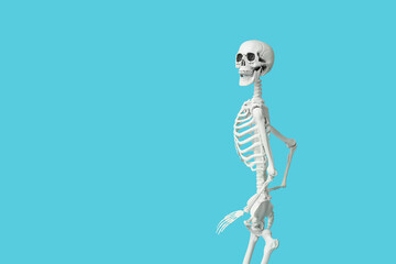 Scary human skeleton running on blue background