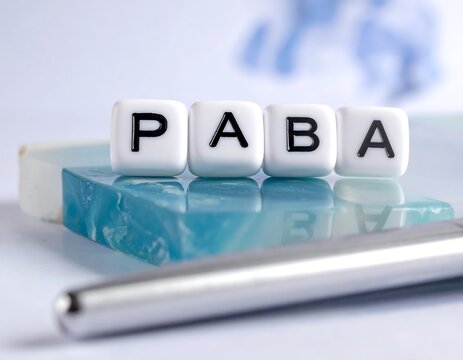 White blocks spelling PABA on a teal-colored surface