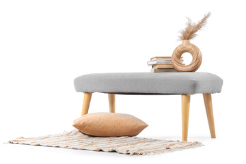 Soft bench with books, pampas grass and rug on white background