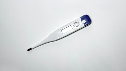 Digital medical thermometer with blue cap isolated on white background