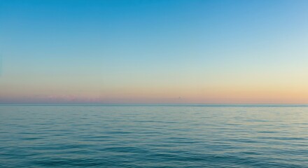 Obraz premium Serene Horizon: A calm sea stretches out beneath a gradient sky. The scene evokes a sense of peace and tranquility.