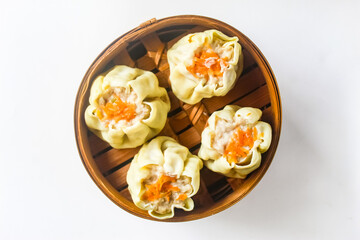 top view of dim sum in a bamboo basket, isolated on a white background.chinese food.asian food.