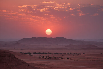 Fototapeta premium Blurred desert horizon at sunset with soft orange glow and surreal minimal background