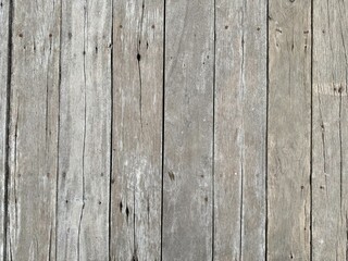 Fototapeta premium Weathered Grey Wood Plank Texture, Close-Up of Weathered Grey and Brown Vertical Wood Planks with Knots and Texture
