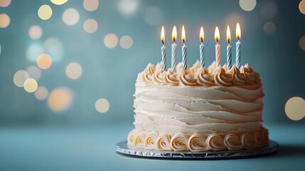 White frosted birthday cake with seven lit candles against a blurred background of warm glowing lights, evoking celebration and joy