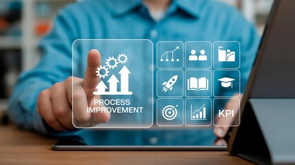 Businessman touching a tablet screen showing process improvement icons representing business growth and key performance indicators