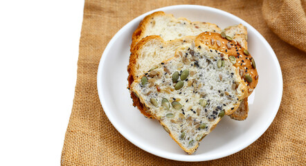 Sliced multigrain bread topped with pumpkin seeds, sunflower seeds, sesame, and black sesame.
