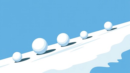 Five round snowballs rolling down a snow covered hillside under a clear blue winter sky