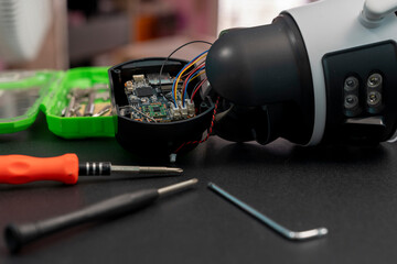 Repairing a wireless CCTV camera on a black background
