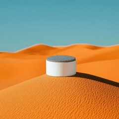 White cylinder podium atop orange desert dunes against vibrant blue sky