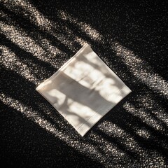 Light beige fabric square, sunlit shadows