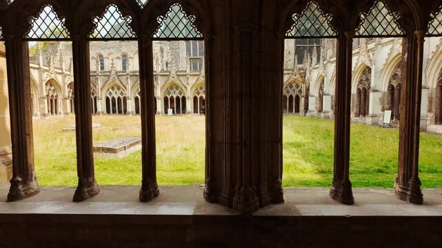 The cloisters of Canterbury Cathedral, Canterbury, Kent, England, UK, with arcaded walks, a quiet garth and stone tracery in soft light
