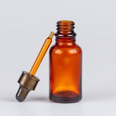 Empty Amber Glass Dropper Bottle with Pipette for Serum or Essential Oil on White