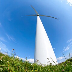 A tall white wind turbine in a field