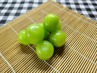 Fresh Green Grapes A Refreshing and Healthy Snack on a Bamboo Mat with a Checkered Background