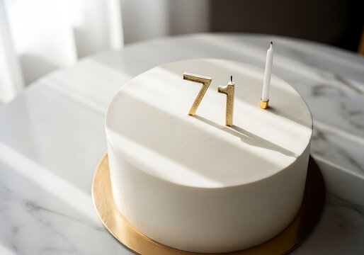 White Birthday Cake with Gold Number 71 Candle and Single White Candle for 71st Anniversary Celebration