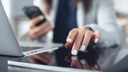 Business woman using digital tablet and mobile phone and working on laptop computer at office. Female student studying online at home, internet technology