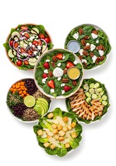Assortment of fresh and vibrant salads featuring various ingredients and dressings displayed beautifully