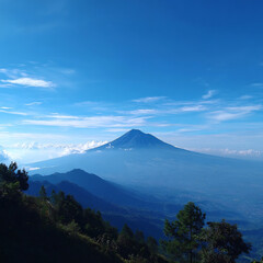 Majestic Mountain Peak Rising Above Clouds Under Clear Blue Sky Panoramic Landscape View