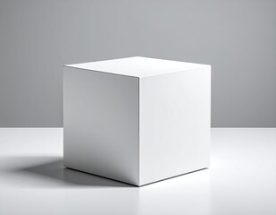Naklejka premium Minimalist white cube object on a clean surface with grey background.