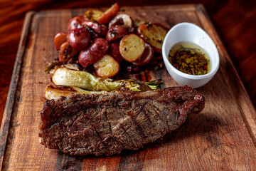 Picaña steak, accompanied by sautéed cambray potatoes and chimichurri