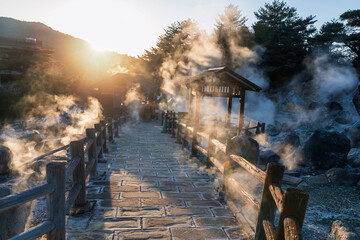 Silhouette people at Unzen Hell Jigoku with sulfur gas at sunset, Nagasaki