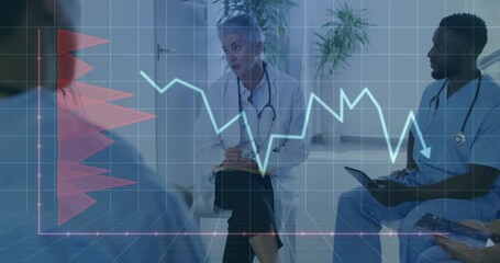 Senior female doctor tapping pen as blue trend line dips, guiding hospital patient data review - Powered by Adobe