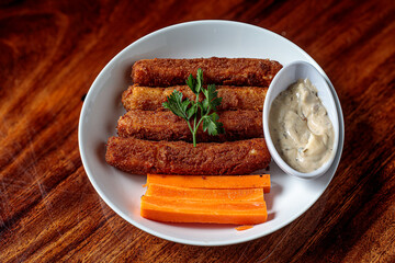 Delicious breaded mozzarella cheese sticks stack with hand 
