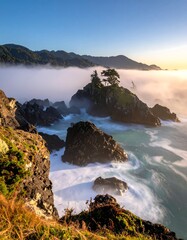 Obraz premium Coastal rocks bathed in sunrise mist