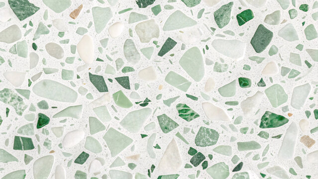 Mixed green terrazzo pattern with jade, emerald, and white stone fragments creating natural mosaic in polished concrete flooring.