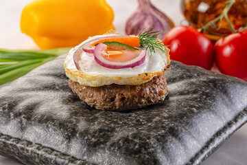 Beefsteak chop with roasted egg