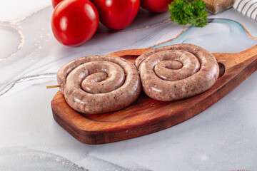 Raw meat pork and beef swirl sausages