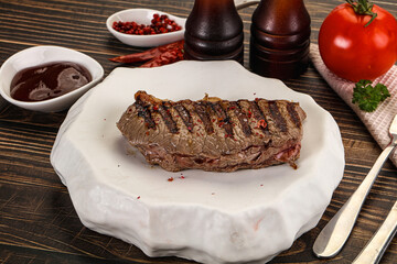 Grilled beef striploin steak with sauce