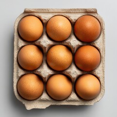 fresh brown eggs arranged in a cardboard box