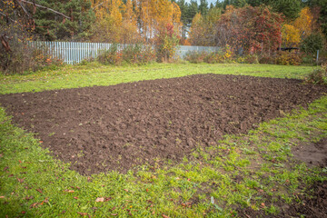 A plowed garden plot on an autumn day