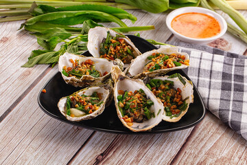 Gournet grilled oysters with onion and peanut