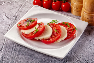 Italian caprese salad with mozzarella, tomato and basil