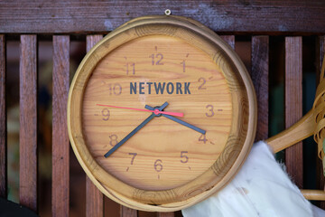 Cloud technology, upload and download concept. Copy space. NETWORK written on Wooden wall clock