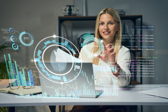 Businesswoman Analyzing Holographic Data Visualizations In Modern Office For Tech Analytics And AI Insights