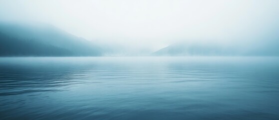 Naklejka premium Misty lake scene, soft blue tones