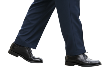 Close-up of man walking in suit pants and black shoes.

