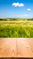 Warm wooden table surface invites you to enjoy a vibrant summer field and clear blue sky, perfect for outdoor product displays or rustic scenes.