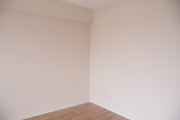 Empty room with neutral colors and wooden flooring