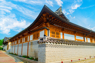 Cloudy day with Traditional Korean house building with tiled roof and wooden structure.Bukchon Hanok Village in Seoul, South Korea.