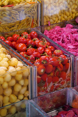 Fresh vegetables and vibrant pickles displayed at a market
