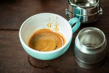 Espresso Tools: Professional Portafilter and Glass Cup with Rich Crema on Rustic Wooden Table Espresso Perfection: Dark Roast Coffee with Crema, Portafilter, and Chrome Machine Parts on Wood